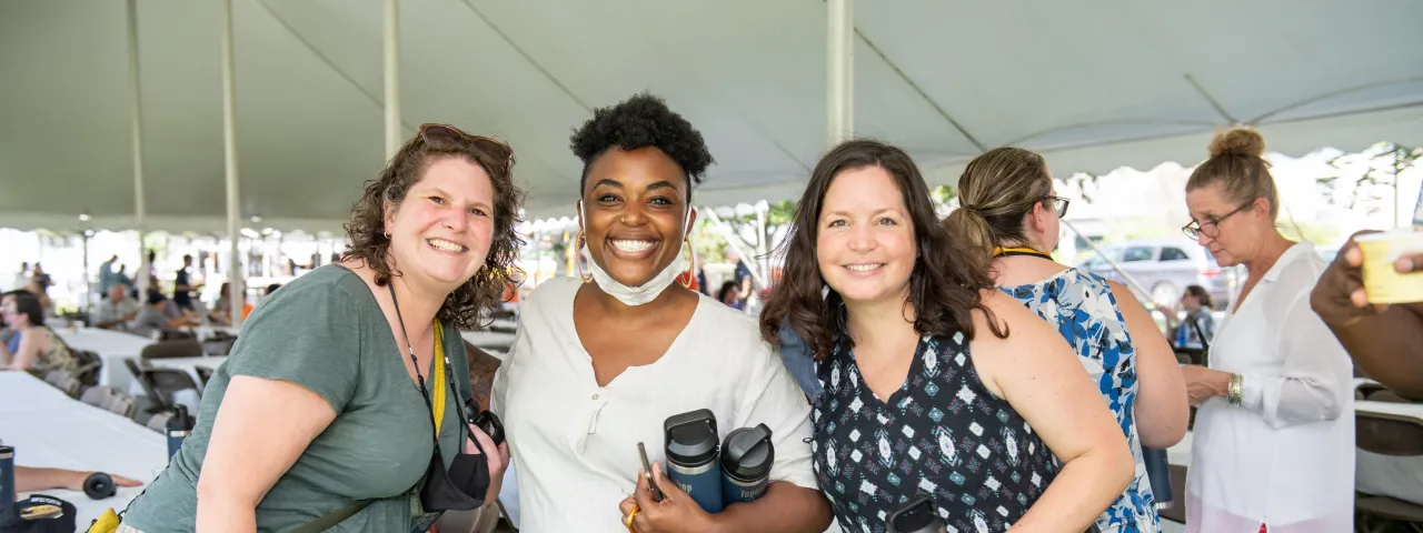 Three staff members at an employee picnic.