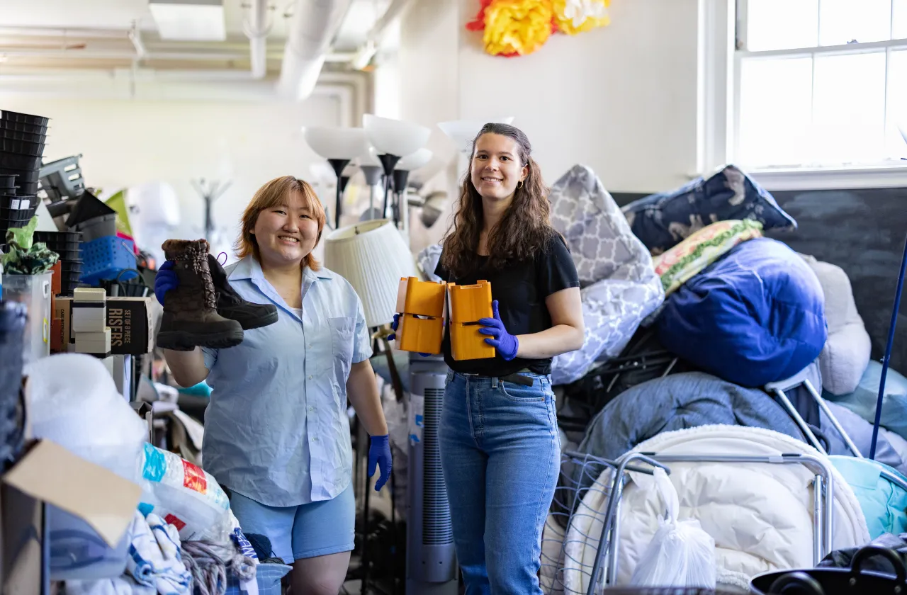 Jena Kim and Molly Neu sorting through items at SmithCycle in Scales House basement