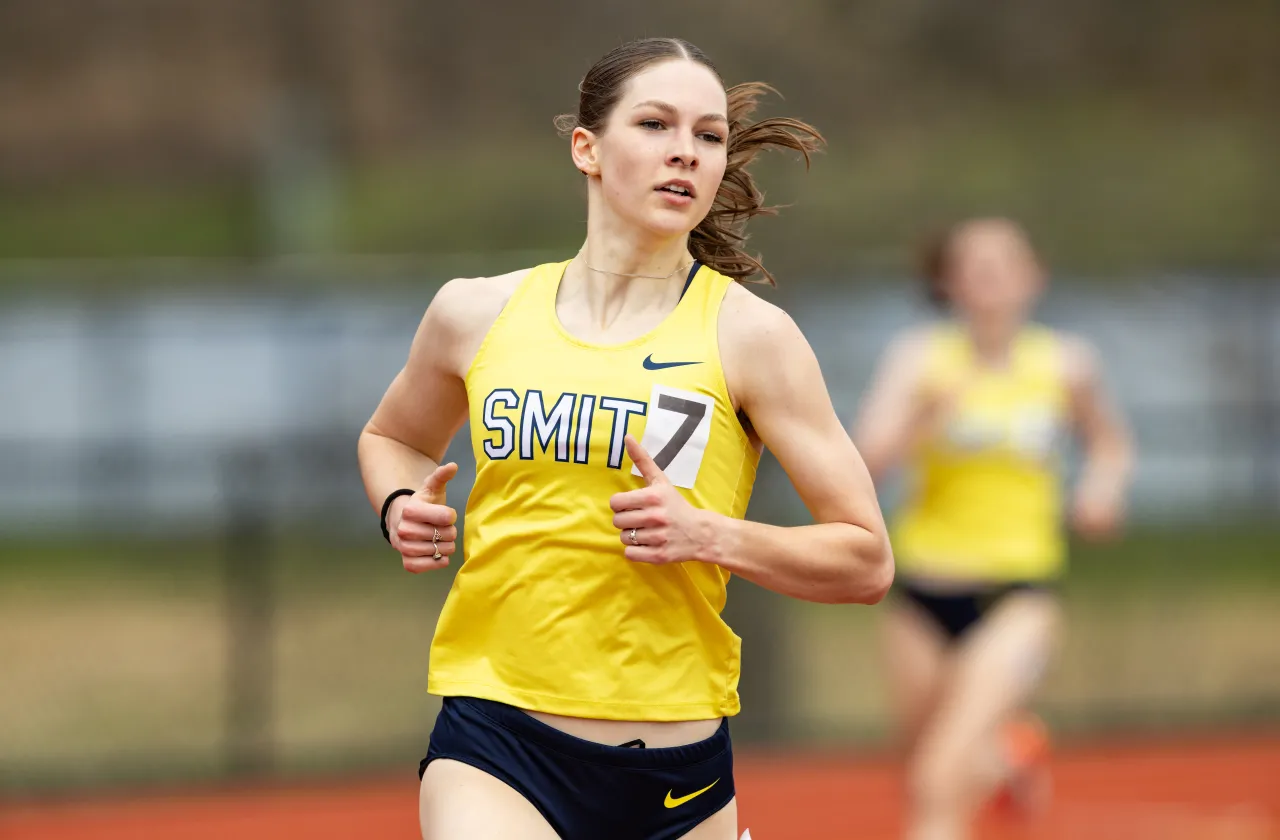 Smith senior Lyda Martin runs on the track in her gold and blue Smith gear