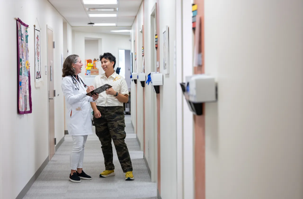 Two Schacht staff members talk in a hallway