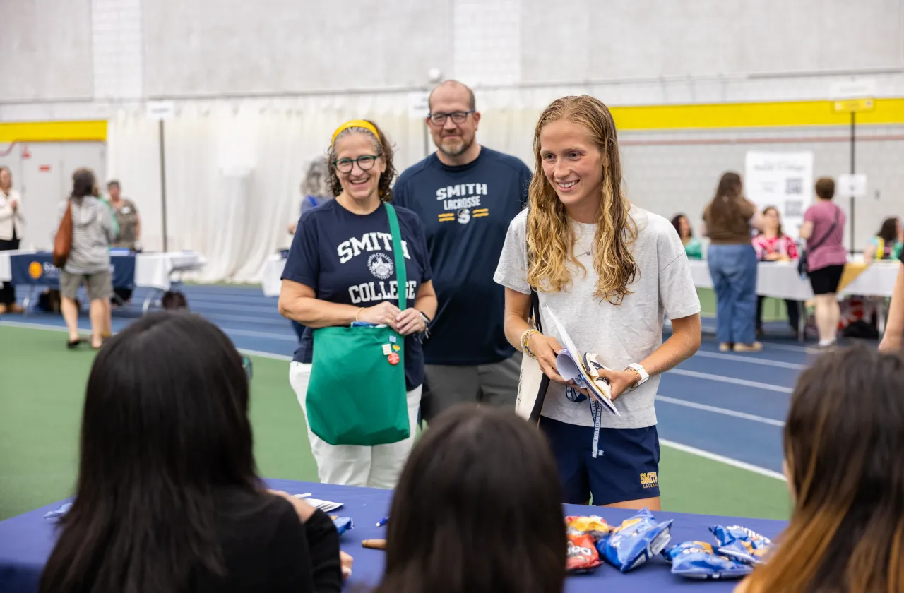 A new student and her parents in the ITT during Central Check-In