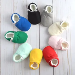 A collection of colored baby shoes arranged in a circle