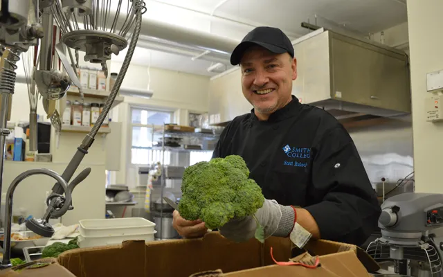 A chef prepares vegetables in the kitchen