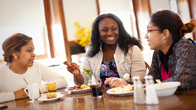 Three students in a dining room