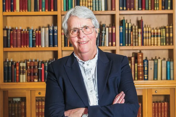 Lucy Marsh smiling in front of a bookcase
