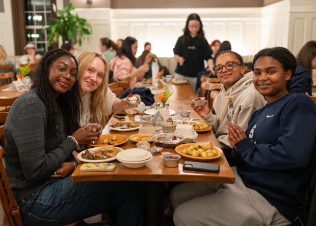 Four students sitting at a table on Julia Child Day