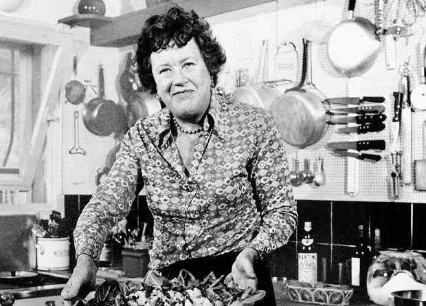 Julia Child presenting a finished dish