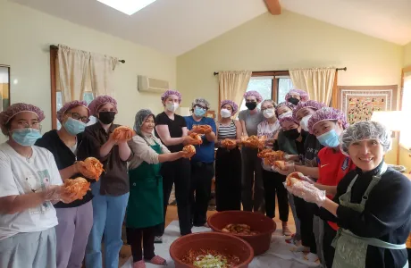 Students holding up finished kimchi