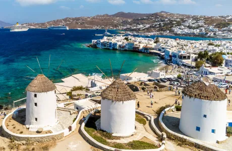White buildings in Mykonos overlooking teal blue water
