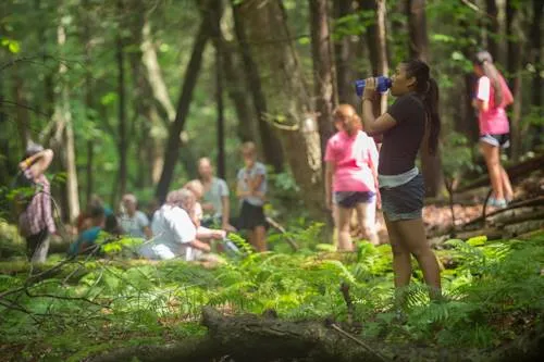 Students standing in the woods.