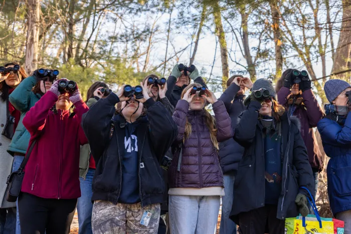 Members of the Uncommon Tits use their binoculars on a bird walk.