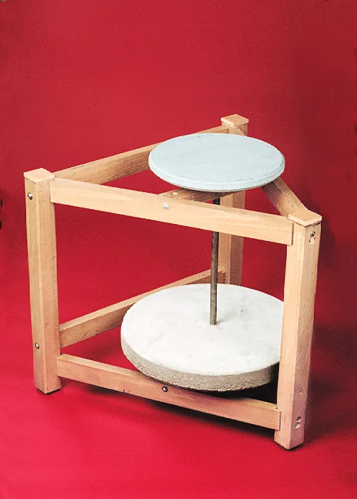 A wooden frame with circular sandstones stacked vertically