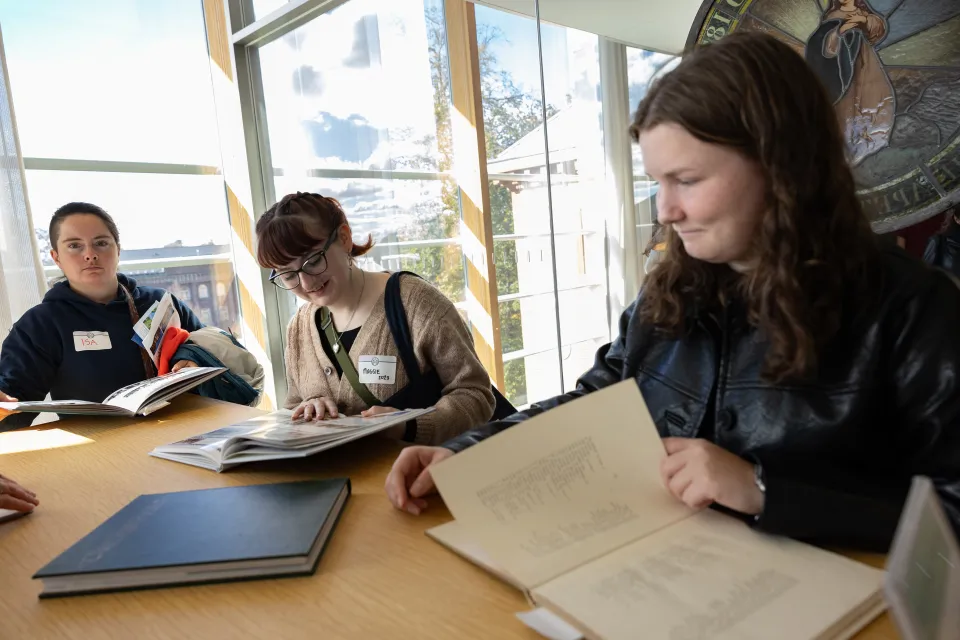 Alums look through old Smith yearbooks during Come Home to Smith