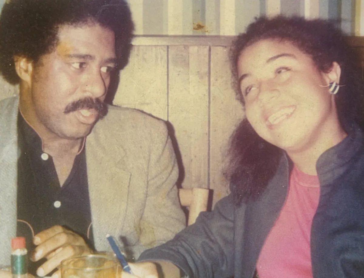 Liz Pryor and her father at a table celebrating her birthday