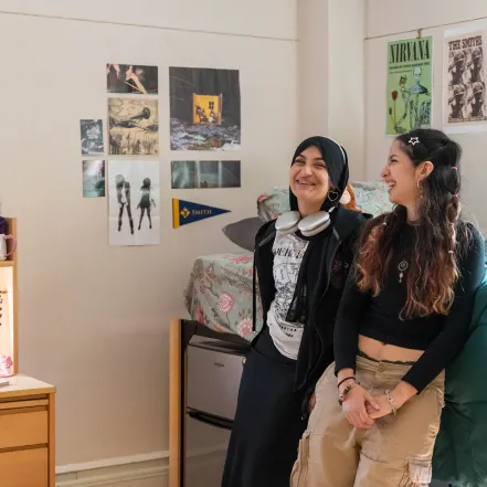Two roommates laugh in their room in Lamont House