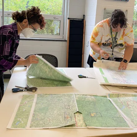 Heather Rosenfeld and a student working on maps.